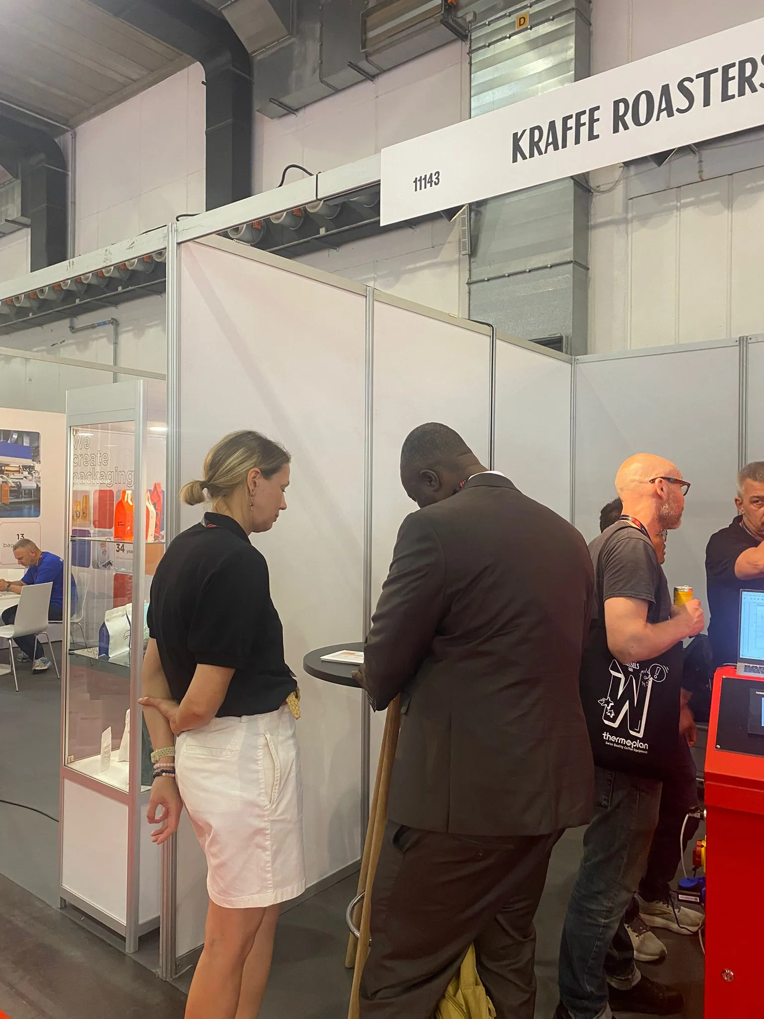 Visitors exploring the commercial coffee roasting machine